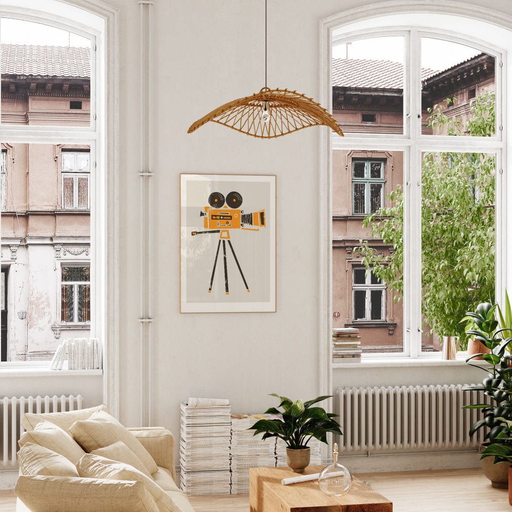 Framed film camera art print displayed in a bright, white room with soft natural light, bringing energy and creativity to the wall with its bold graphic style.