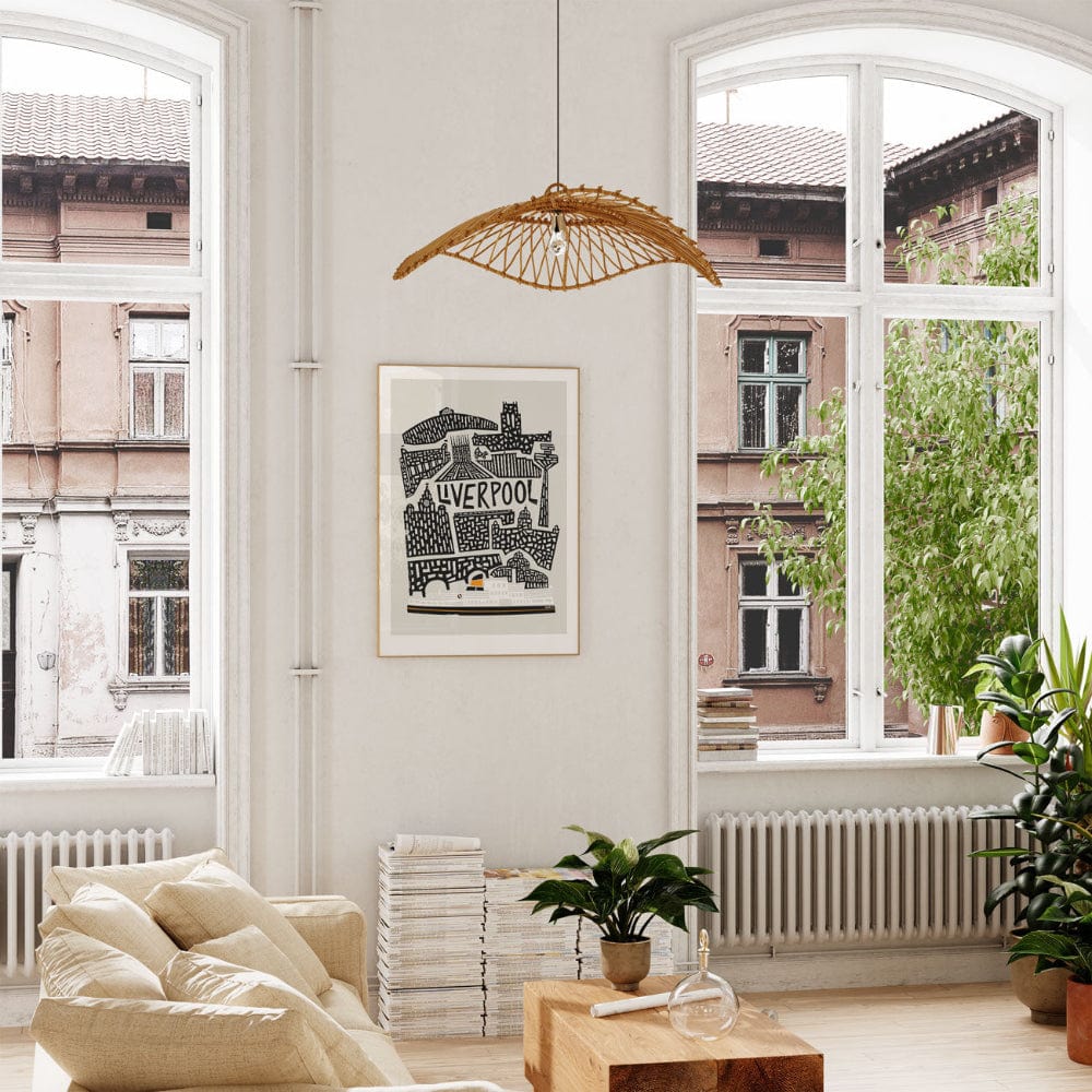 Framed Liverpool skyline artwork displayed by a window with soft natural light, bringing a modern graphic touch to a bright living space.