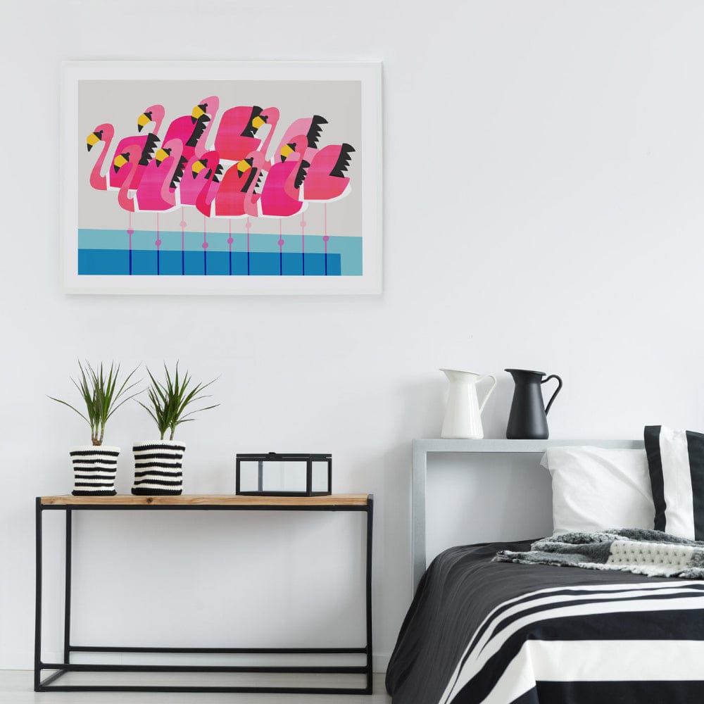 Graphic flamingo illustration hanging above a bed, adding a fun pop of pink to the room.