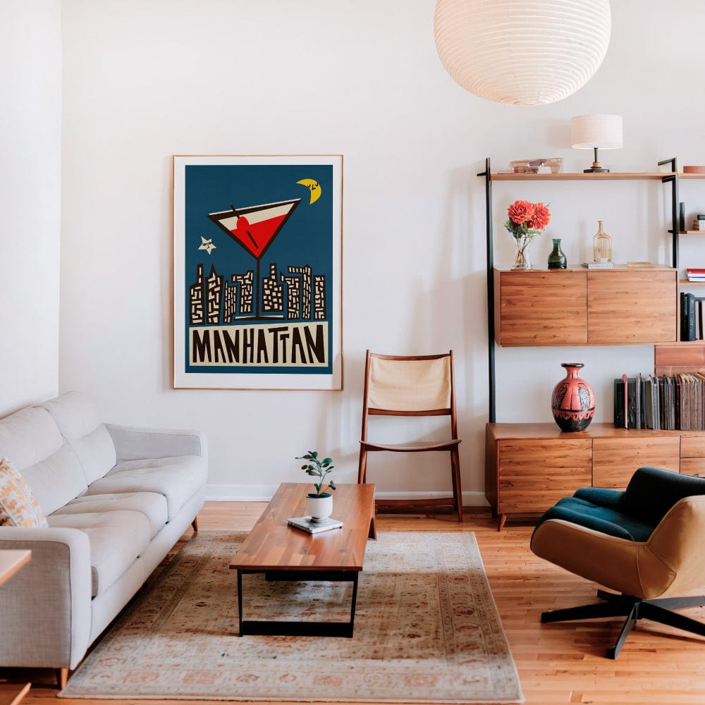Cocktail and skyline print framed in a warm, inviting lounge with wood tones and mid-century furniture.