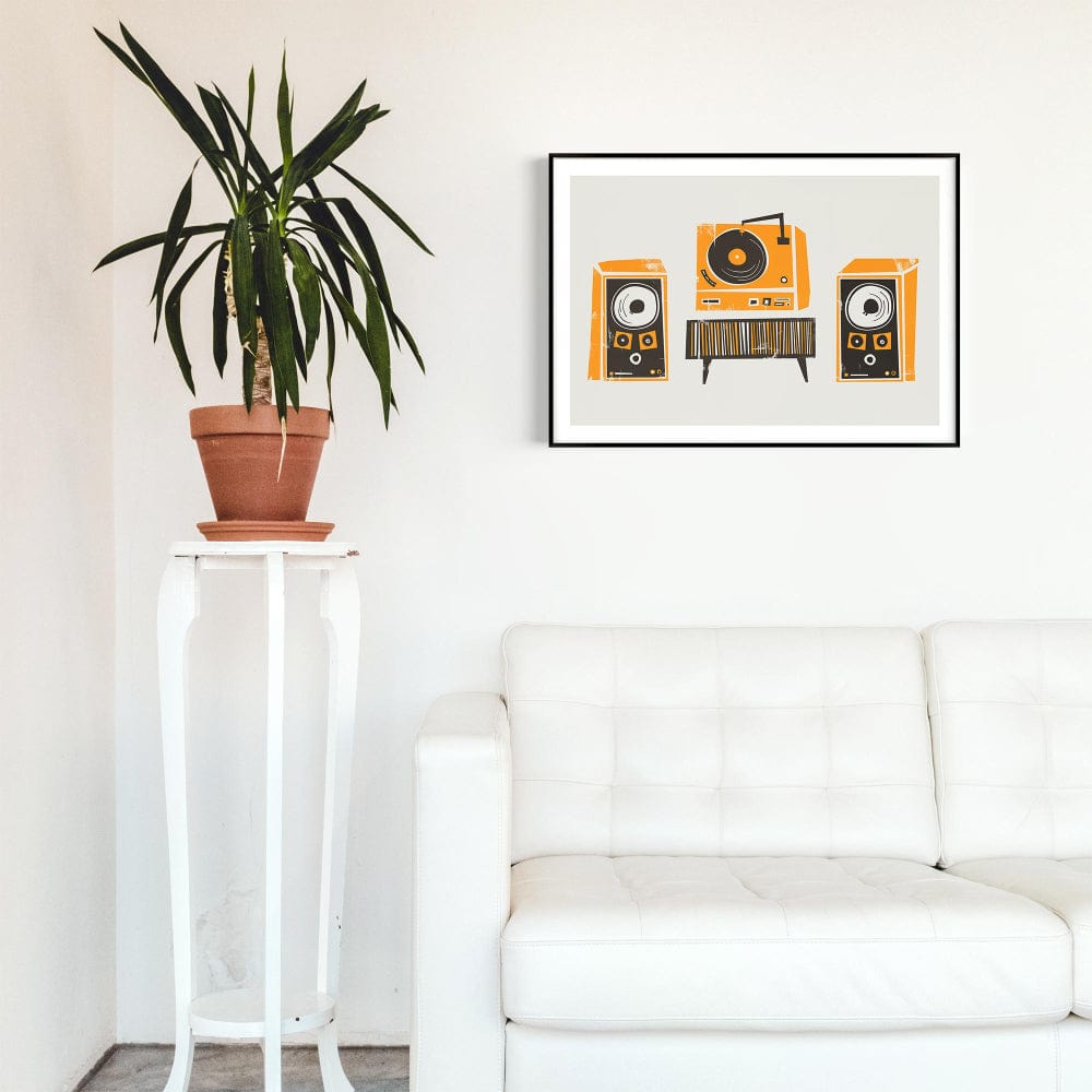 Retro stereo print hanging above a white sofa with a tall plant in a bright, modern room