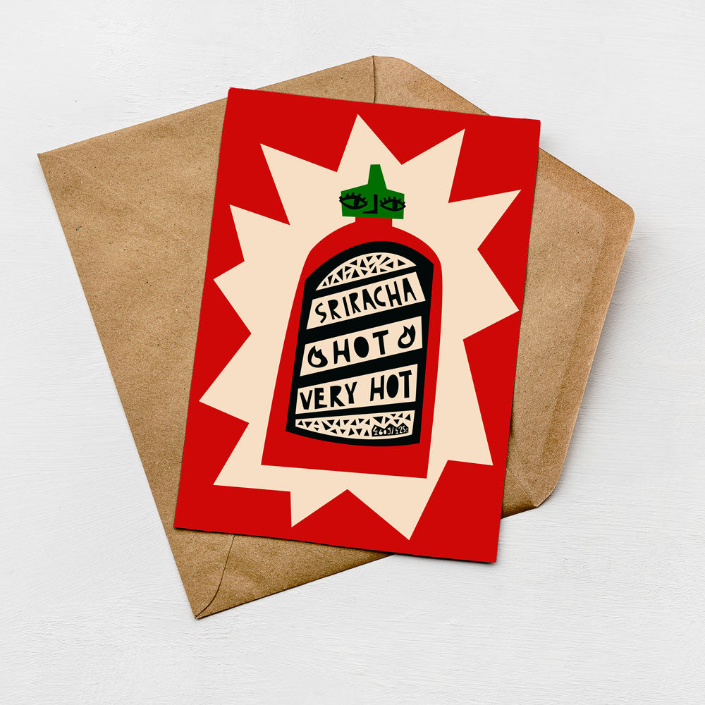 A greeting card with a red background and a graphic of a hot sauce bottle.