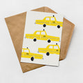 a greeting card with a design of yellow taxis on a white background.