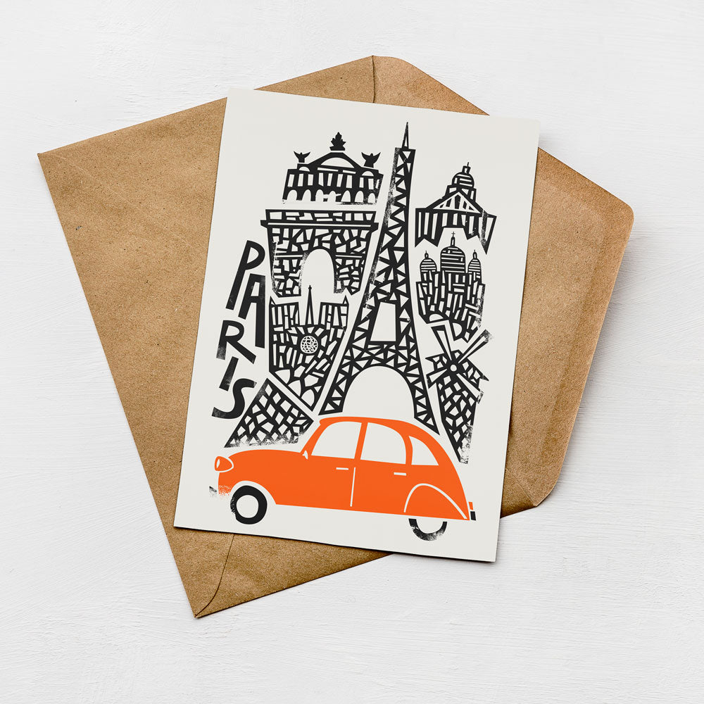 A card featuring an illustration of the Eiffel Tower and an orange car, with the word "PARIS" written on the card.