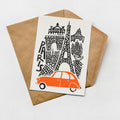 A card featuring an illustration of the Eiffel Tower and an orange car, with the word "PARIS" written on the card.