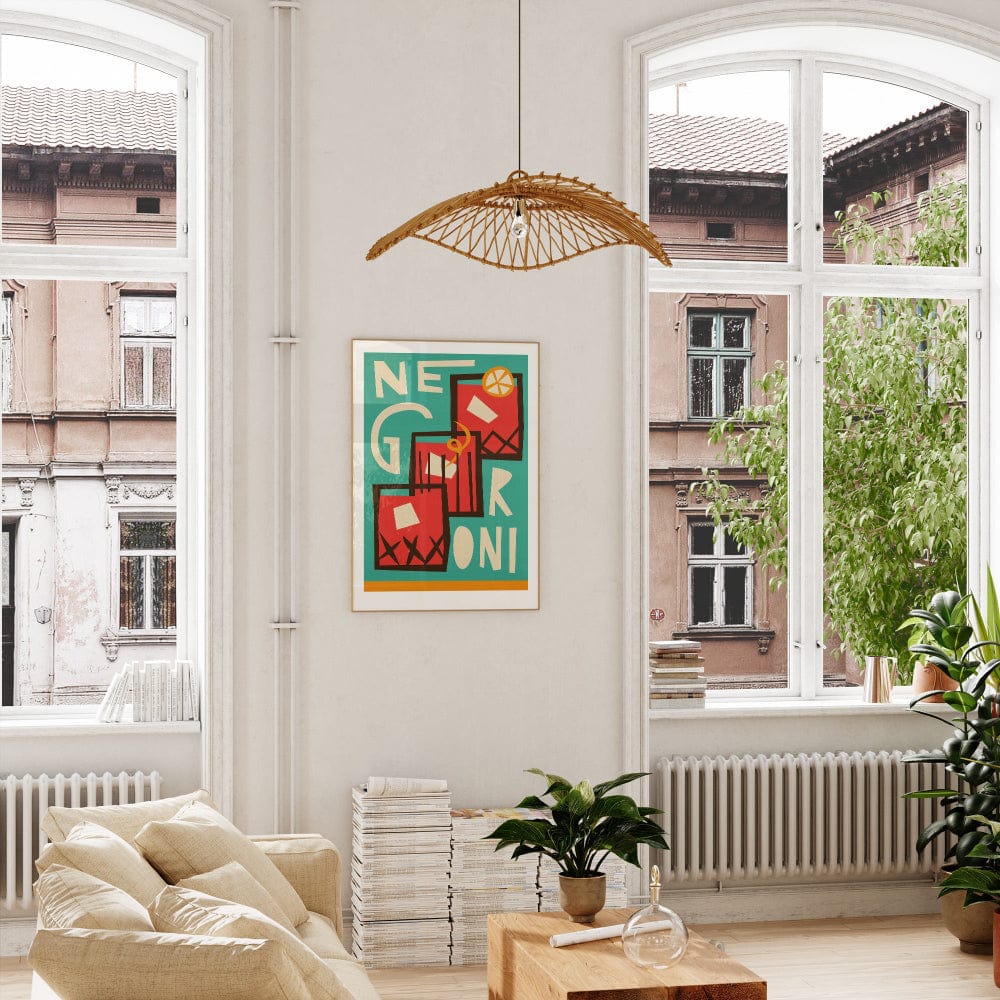 Negroni art print hanging in a bright room with tall windows and greenery, adding a punch of colour.