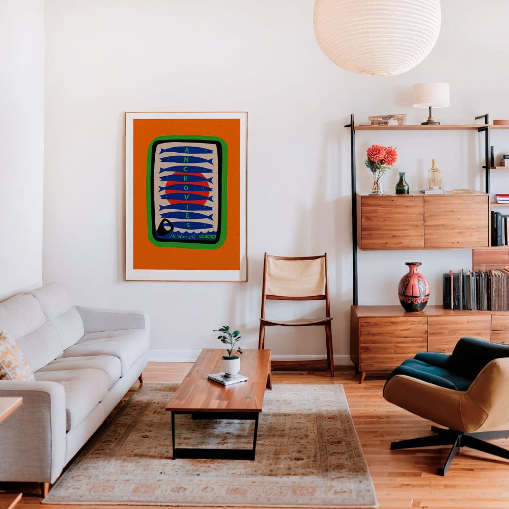 Anchovy print framed in white-walled living room with mid-century furniture and soft lighting