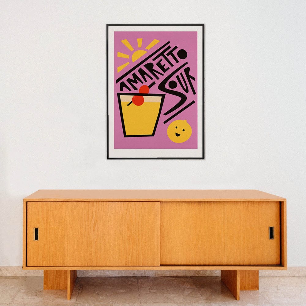 Amaretto Sour cocktail print framed above a clean wooden cabinet, styled with a bright retro colour palette.