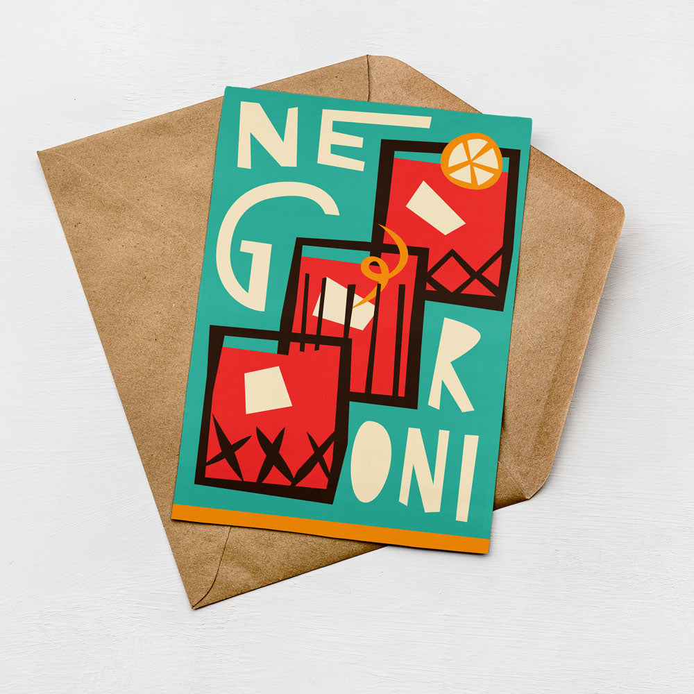 A colorful greeting card with a teal background and various geometric shapes and patterns, including a lemon slice and a red and black striped design.