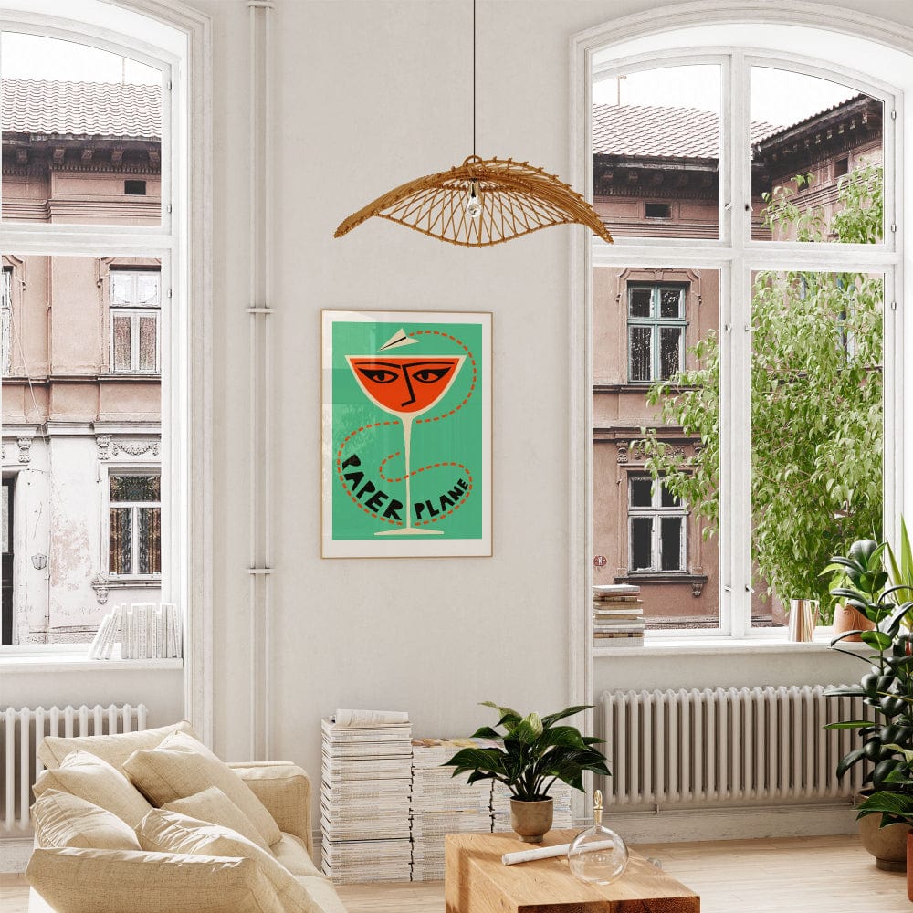 The framed print hung in a soft-toned, leafy living space where the mint background and graphic red-orange create a bold visual contrast.