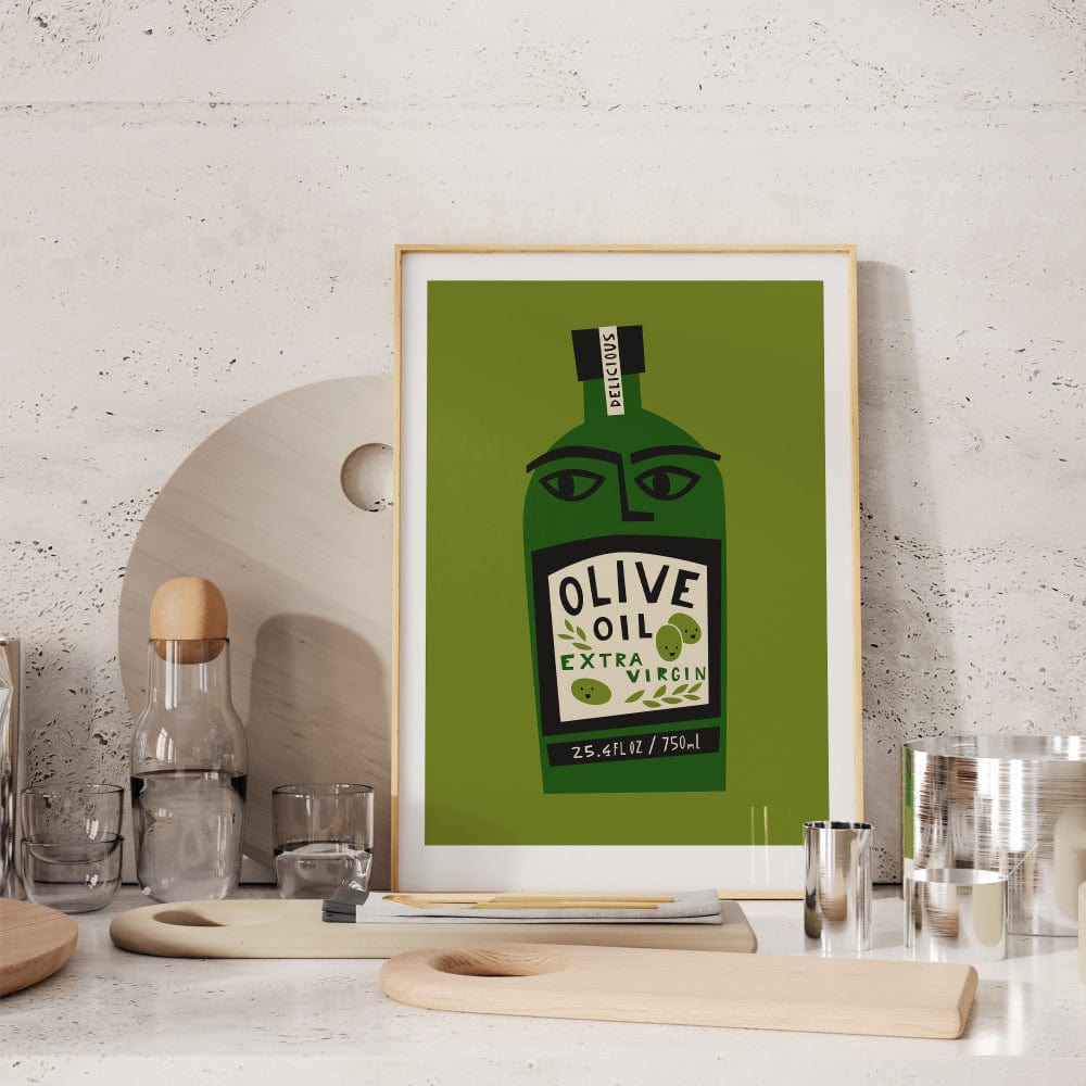 Framed olive oil print displayed on a shelf with ceramics and drinking glasses in a light kitchen setting