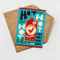 A colorful envelope with a printed design featuring a hot sauce bottle and various text elements.