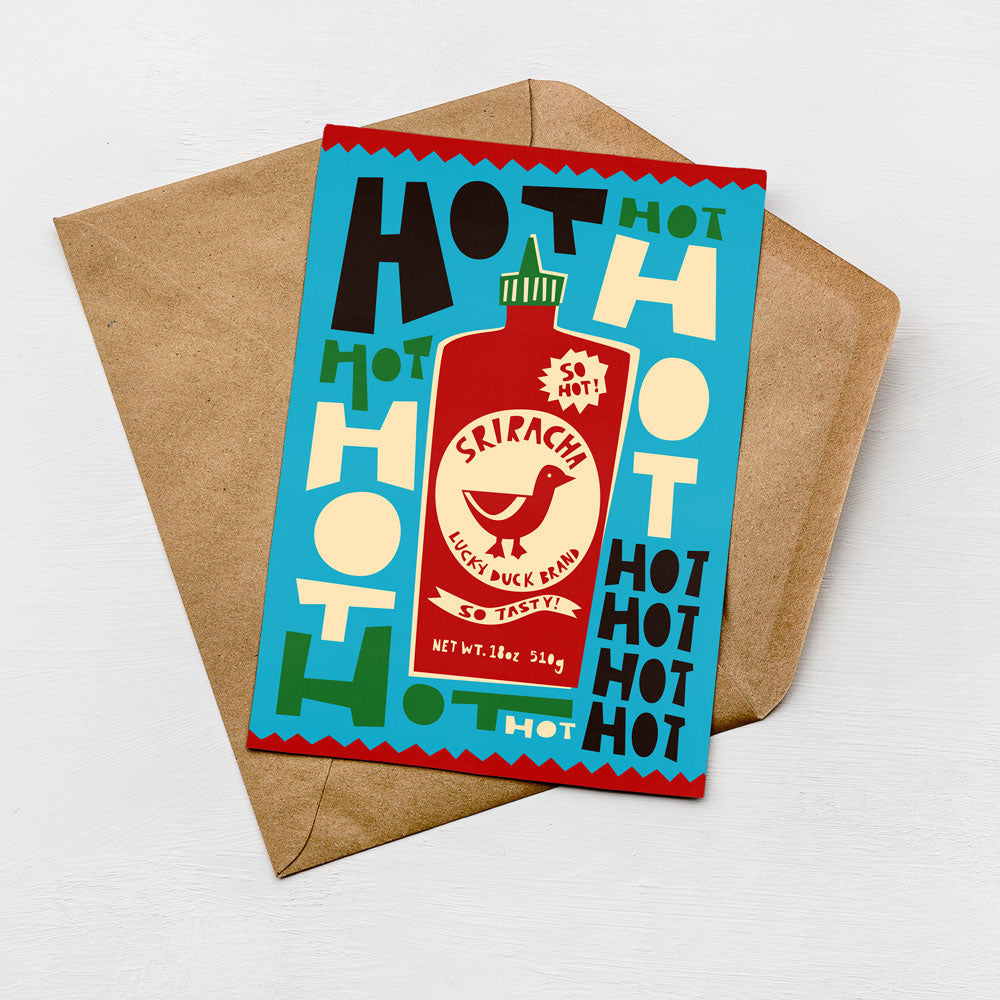 A colorful envelope with a printed design featuring a hot sauce bottle and various text elements.