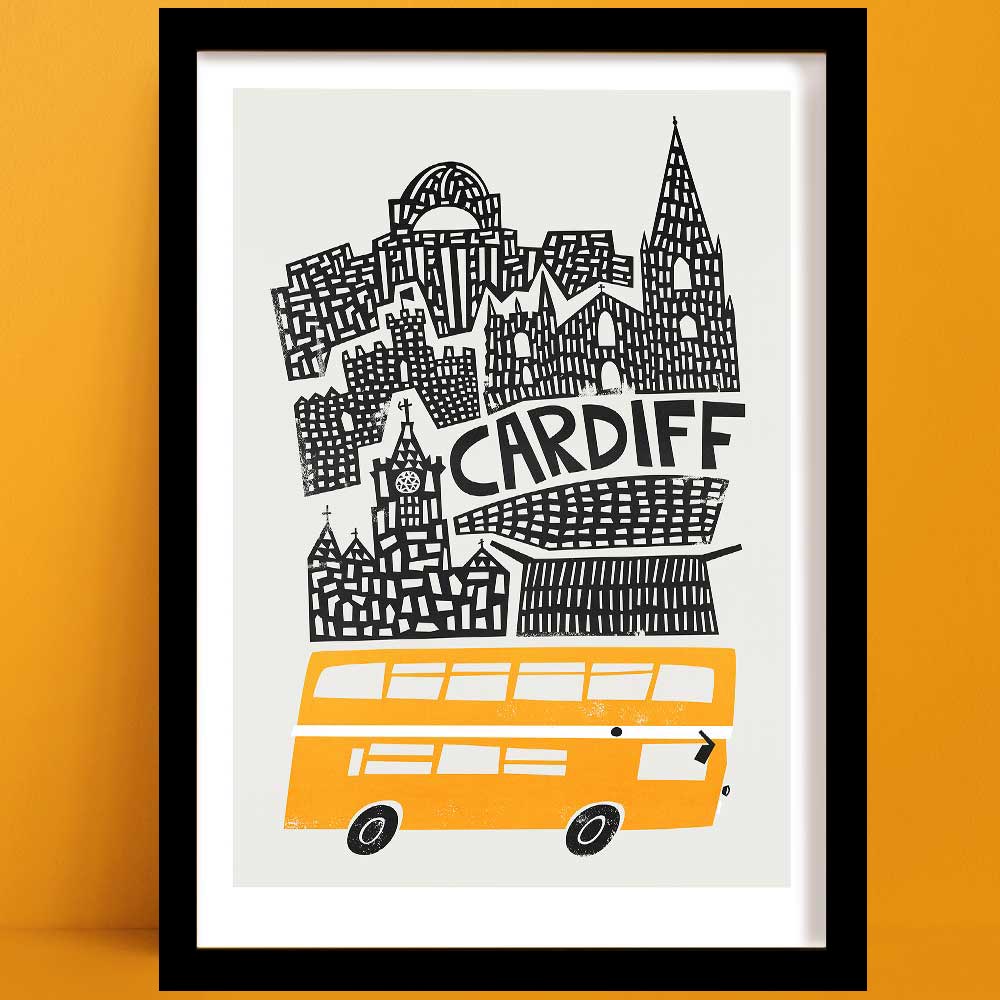 A Cardiff print with a striking black-and-white illustration of Cardiff’s iconic buildings, with a bright yellow double-decker bus beneath.