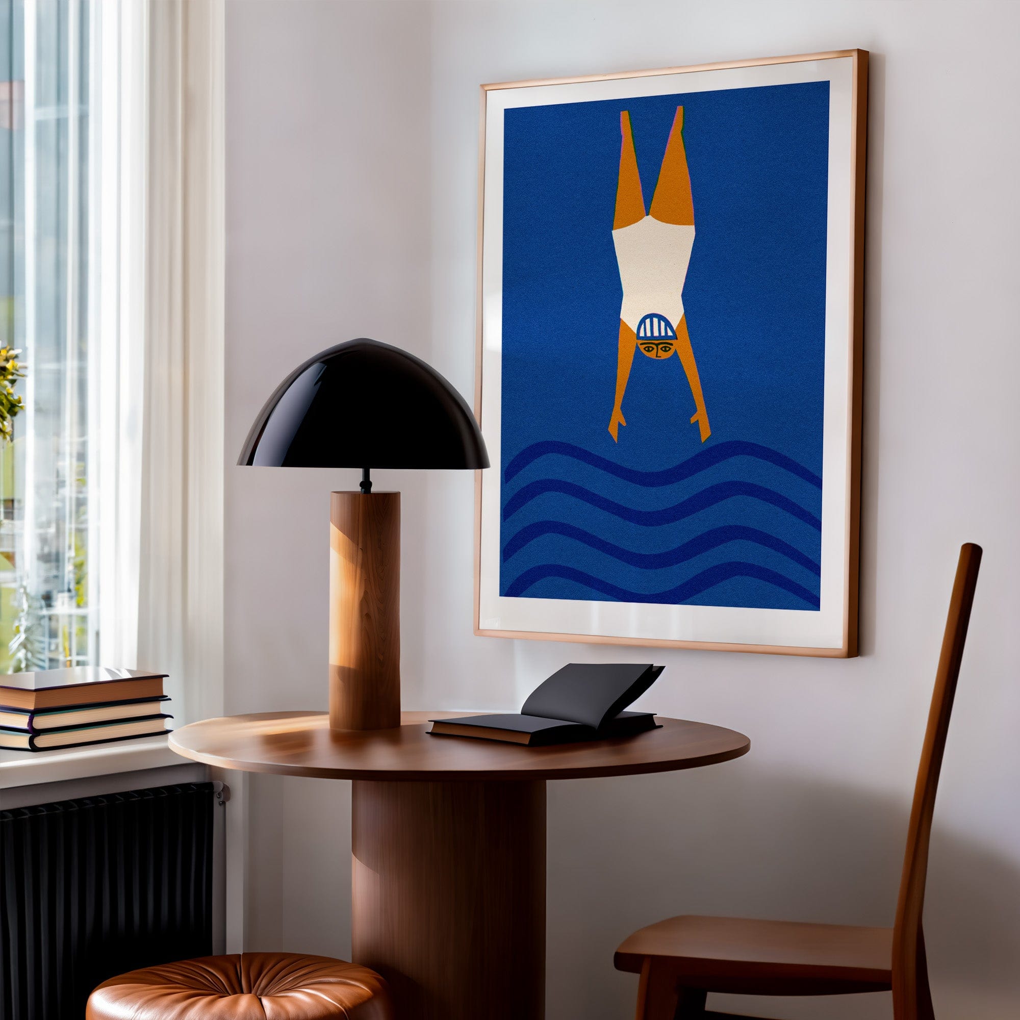 Diving swimmer print framed above desk in calm, light-filled home workspace