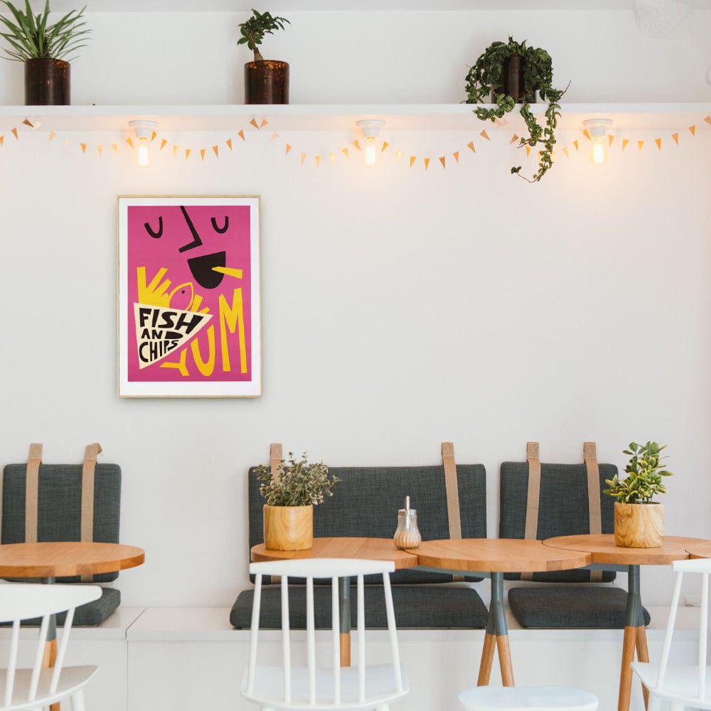 Eye-catching food poster brightening a minimalist café dining space with string lights and greenery.