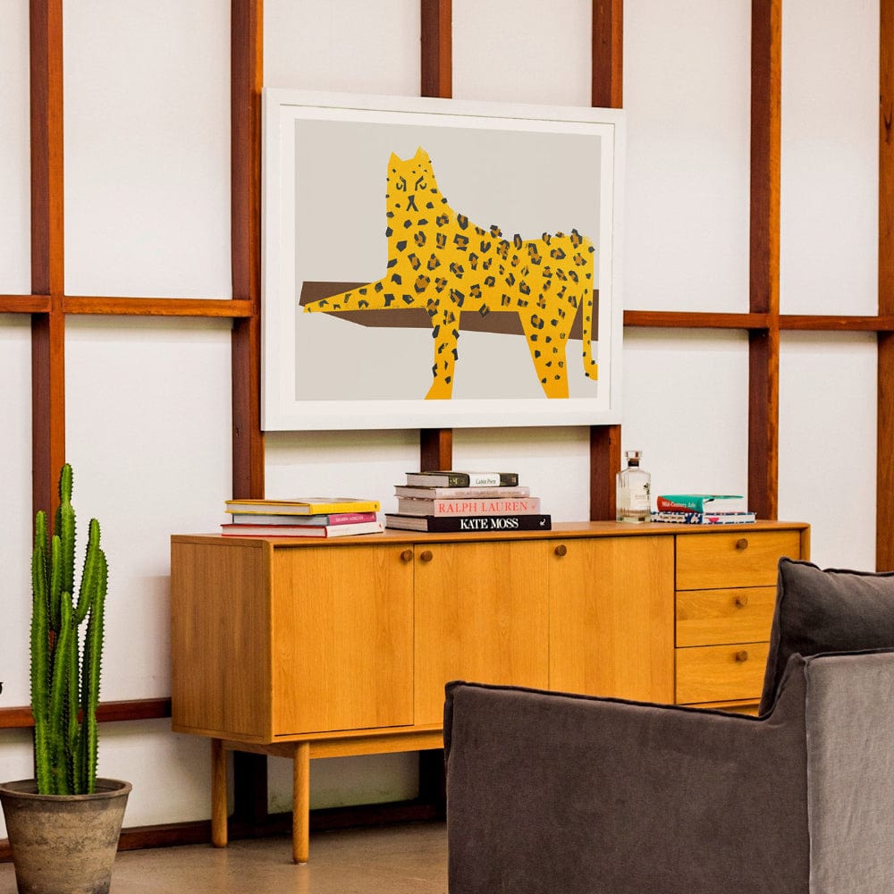 Leopard wall art adds character to a wood-panelled mid-century workspace.