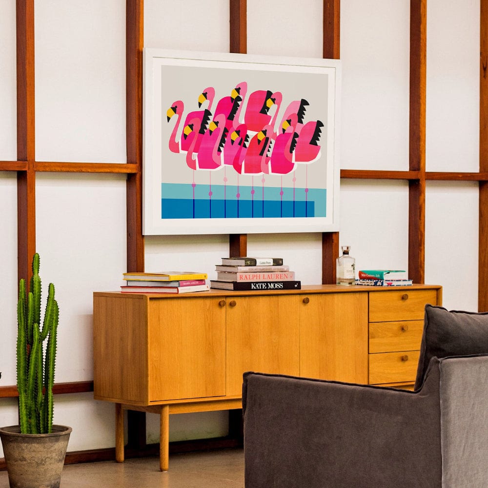 Bold flamingo art displayed in a mid-century styled home office for a quirky, modern touch.