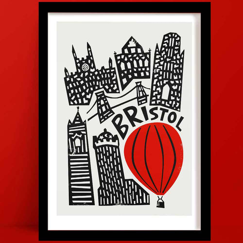 A Bristol print featuring a Bold black-and-white illustration, with a striking red hot air balloon and silhouette buildings.