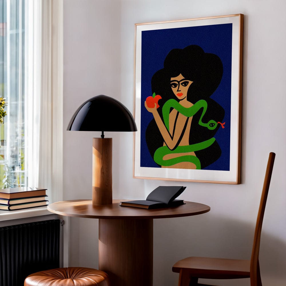 Eve and the Serpent artwork hanging beside a wooden desk in a softly lit modern home office