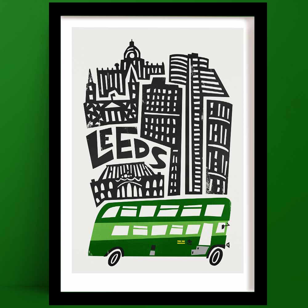 A Leeds Print with a black and white illustrated city skyline, featuring bold, blocky architecture and the word “LEEDS” integrated into the skyline, anchored by a classic green bus.