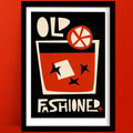 Old Fashioned cocktail print with a bold glass illustration, abstract orange slice and star anise shapes, framed on a deep terracotta wall.