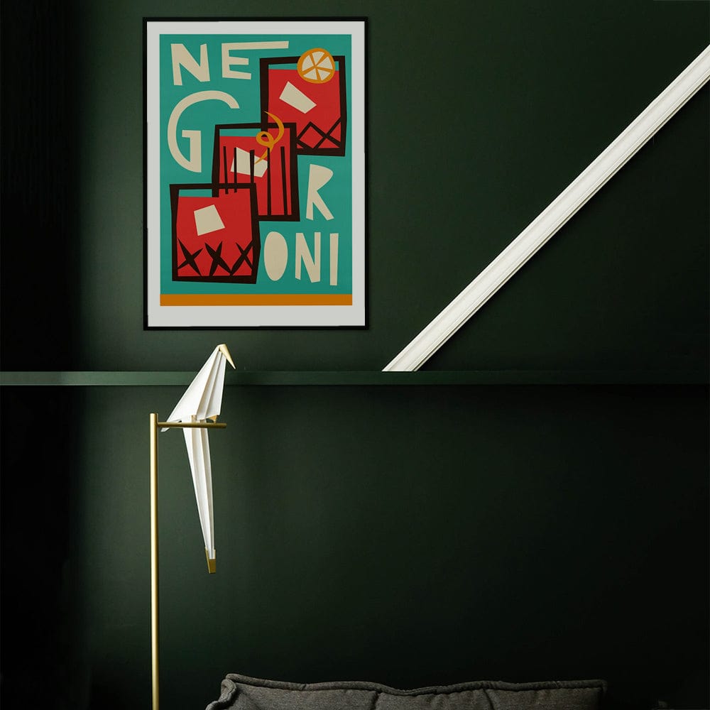 Bold cocktail artwork styled in a dark moody space, creating contrast and a mid-century modern vibe.