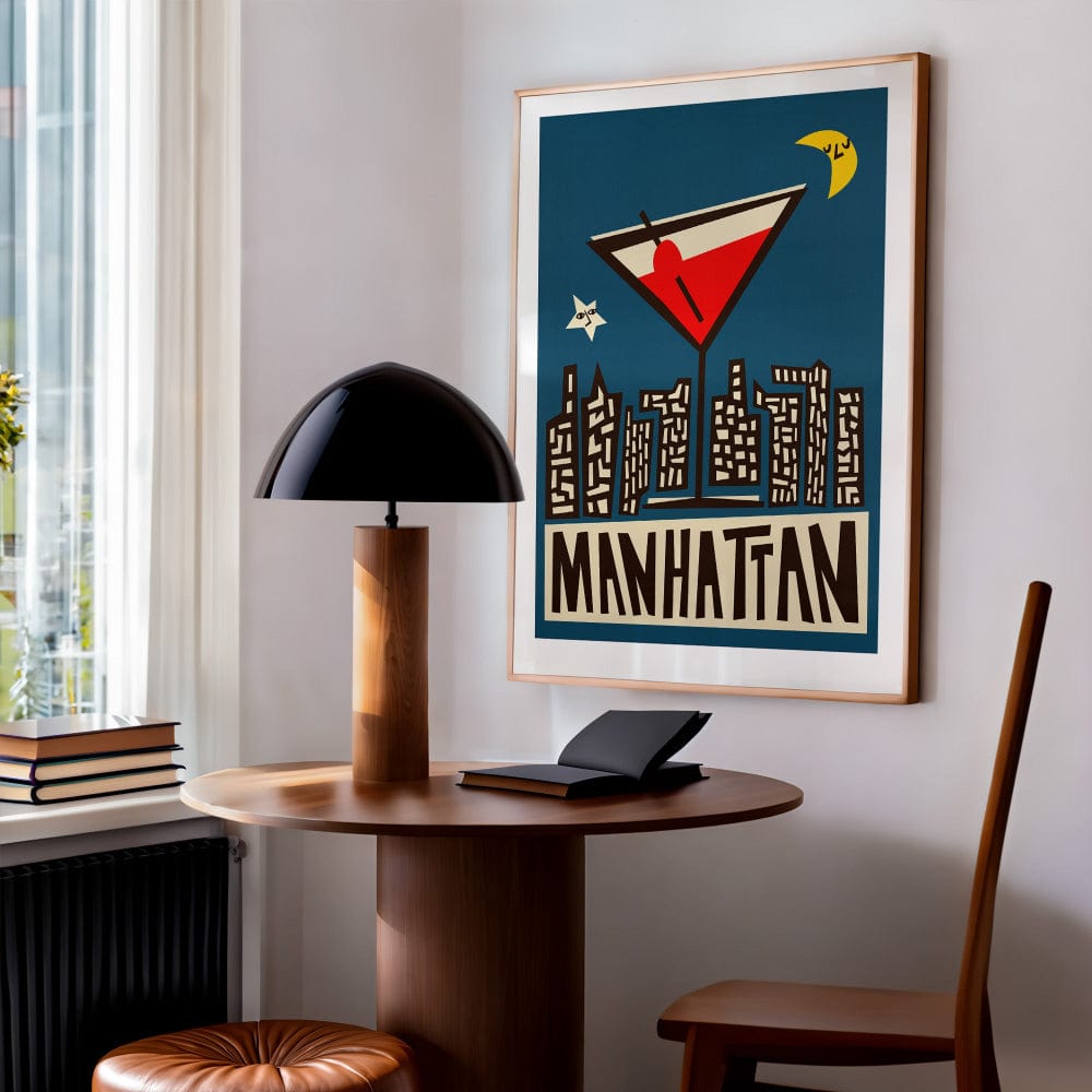 Retro cocktail artwork styled in a small modern nook with books, wood, and soft daylight from nearby windows.