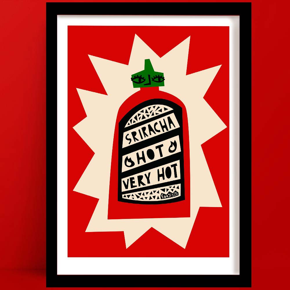 Sriracha sauce print featuring a graphic red bottle with hand-lettered label and bold burst backdrop, framed on red wall.