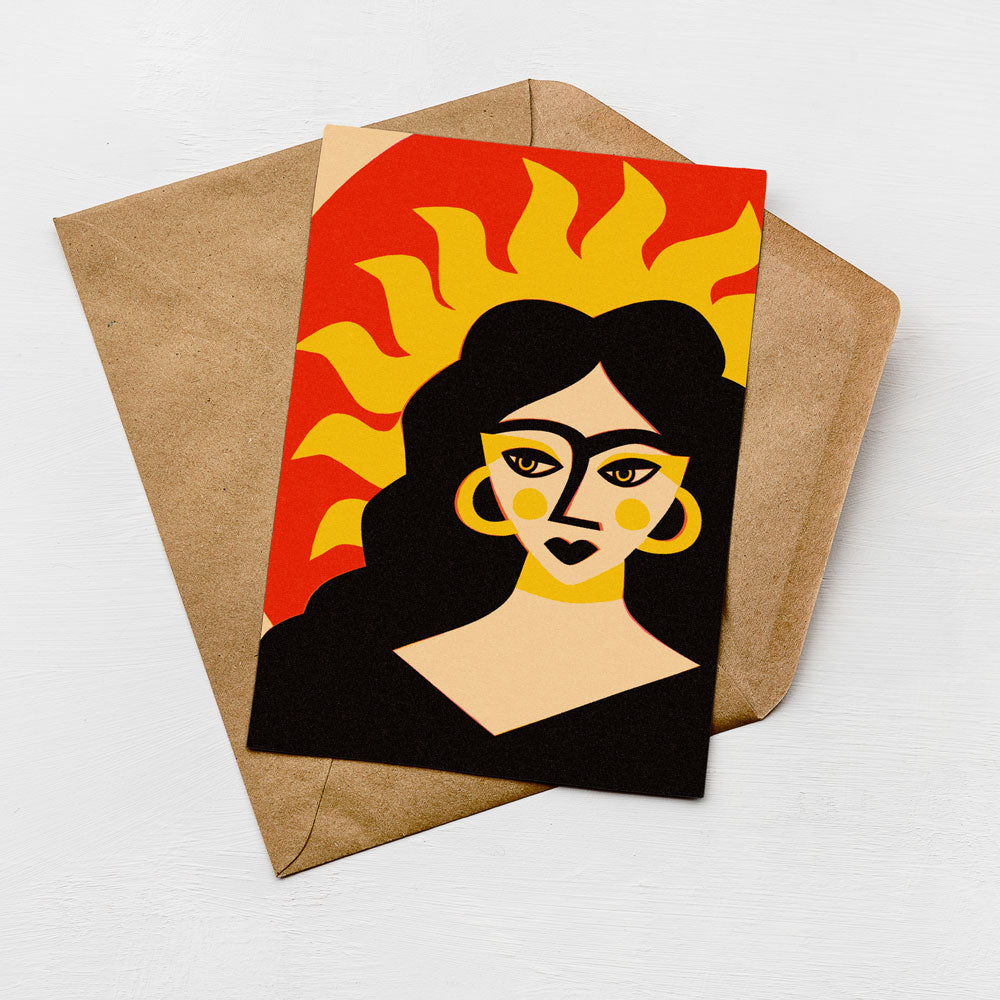 a card with a stylized illustration of a woman's face, including a sun-like design above her head.