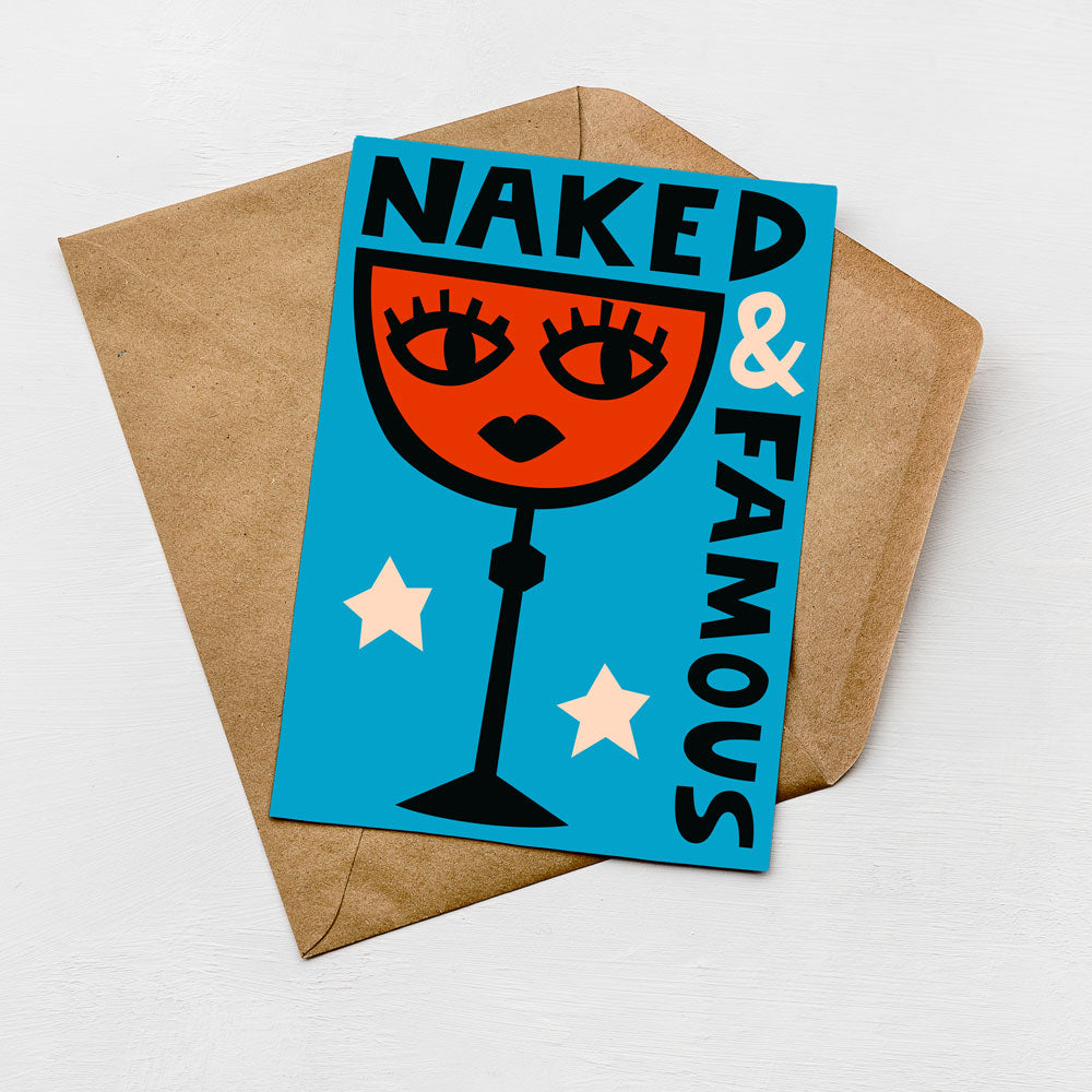 A greeting card with a stylized illustration of a wine glass and the text "Naked & Famous" on it, placed on a brown envelope against a white background.