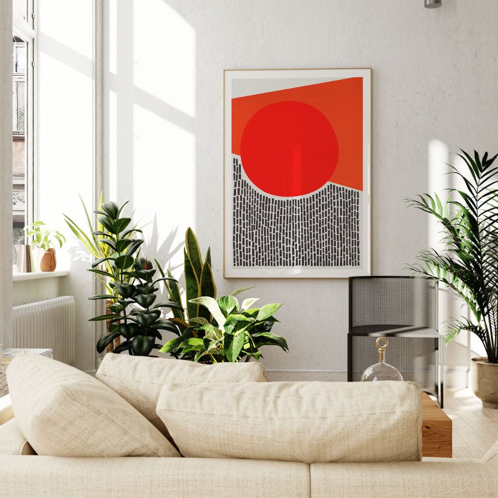 The red circle abstract print displayed in a sunlit living space, its bold geometric form adding warmth and graphic impact to a calm and neutral-toned room.
