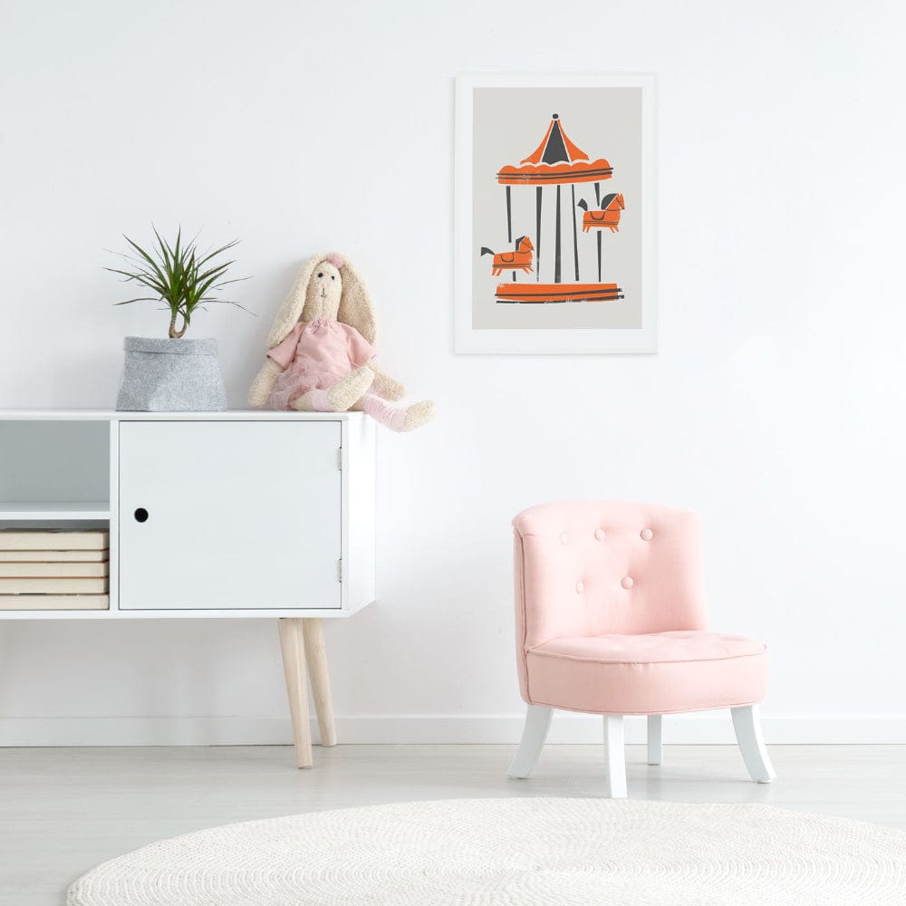 Framed carousel horse artwork in a child’s room, styled with pale furniture and pink chair