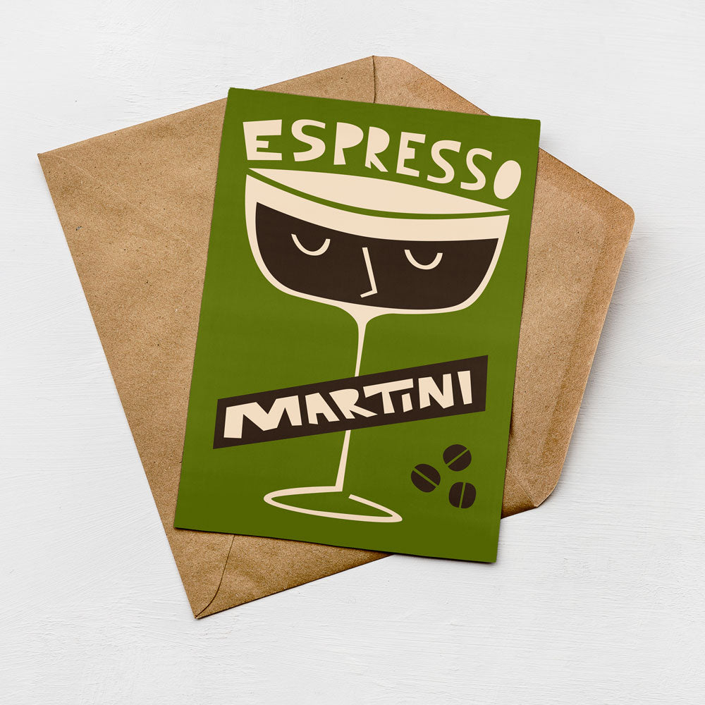 A green card with a stylized illustration of a martini glass and the text "ESPRESSO MARTINI" printed on it, placed on a brown envelope.