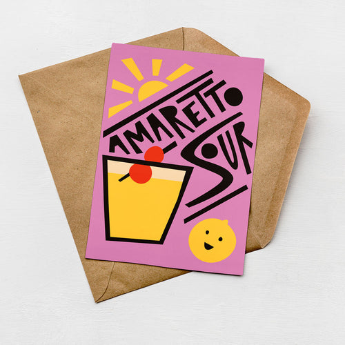 A colorful greeting card with a stylized illustration of a cocktail glass and a lemon, along with the text "AMARETTO SOUR" written in a playful font.